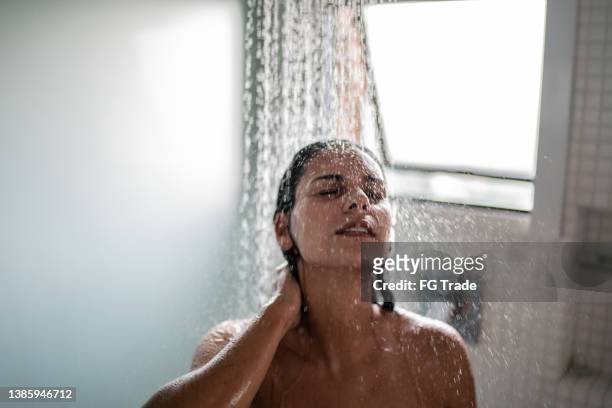 woman taking a shower at home - women taking showers stock pictures, royalty-free photos & images