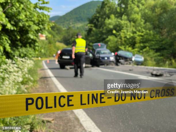 police yellow line on traffic accident - car crash scene stock-fotos und bilder