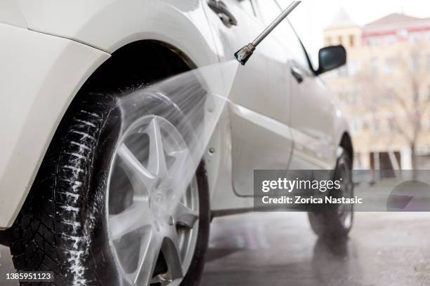 car wash with a hose - car wash stock pictures, royalty-free photos & images