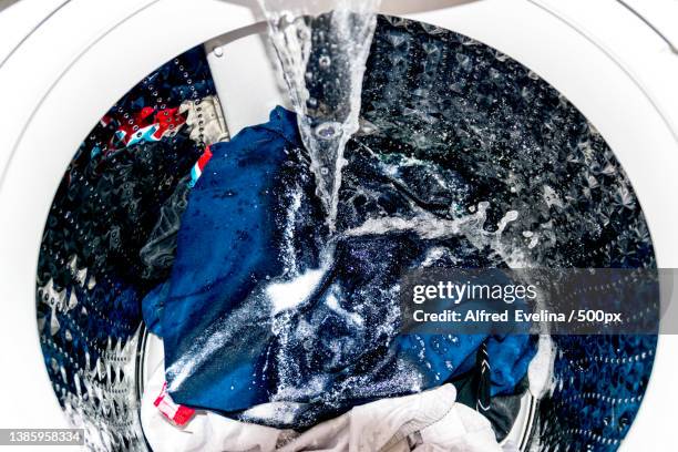 close-up of washing machine running full cycle soapy water - waschmittel stock-fotos und bilder