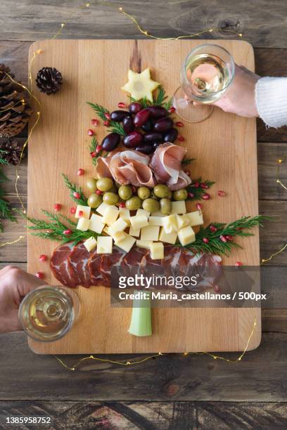 directly above view of spanish cheese and sausage board in the shape of a christmas tree for two - maria castellanos stock pictures, royalty-free photos & images