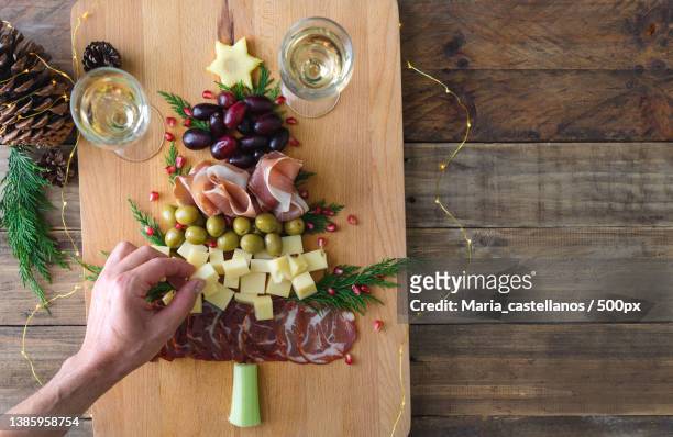 spanish cheese and sausage board in the shape of a christmas tree - maria castellanos stock pictures, royalty-free photos & images