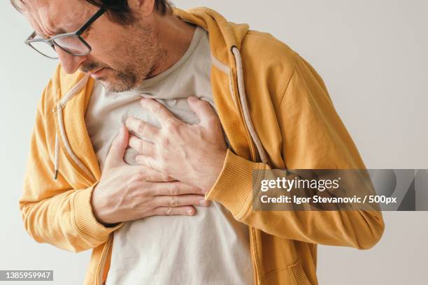 aching chest adult male with painful grimace,serbia - shingles illness stock pictures, royalty-free photos & images