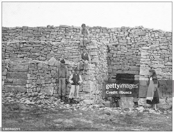 antique travel photographs of ireland: ancient celtic fortress, aran islands - aran islands stock illustrations