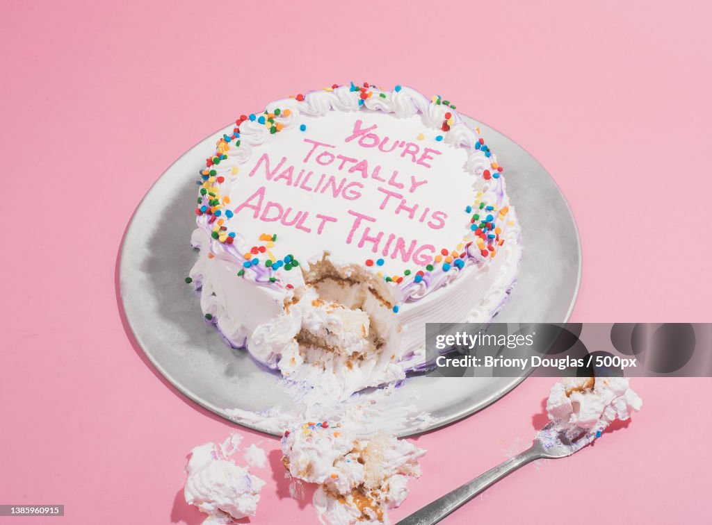 High angle view of cake with text against pink background