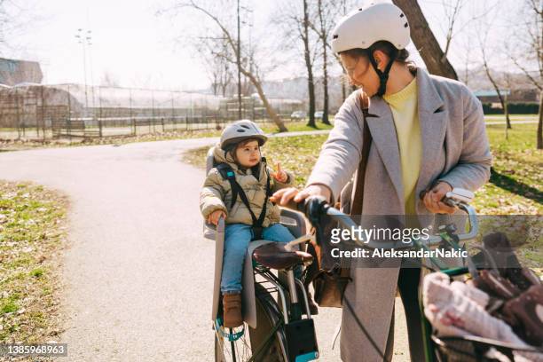 commute to kindergarten with mom by bicycle - baby clothes bildbanksfoton och bilder