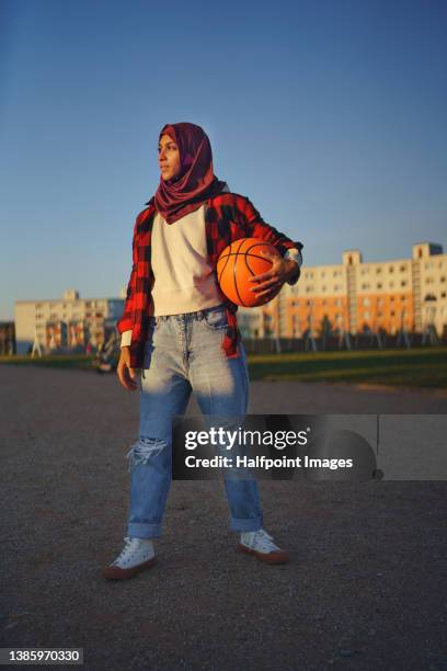 muslim young woman outdoors in the city, with basketball. - sport for life stock pictures, royalty-free photos & images
