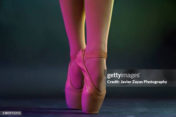 low section of ballet dancer woman dancing on dark stage - ballet feet hurt stock pictures, royalty-free photos & images