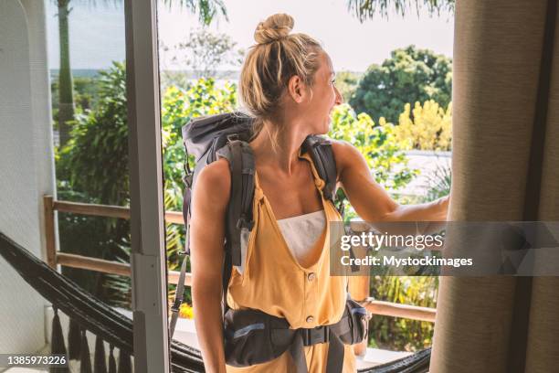 female travel backpacker arrives at the accommodation in tropical destination - hostel stock pictures, royalty-free photos & images