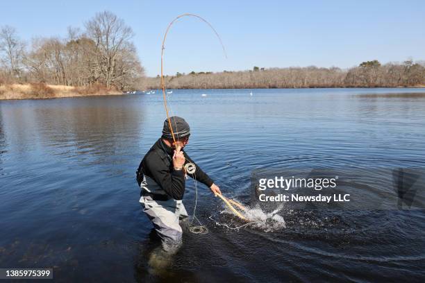 Frank Oliva, of Bayport, catches a brook trout in the main pond at Connetquot River State Park Preserve in Oakdale, New York, on March 16, 2022.