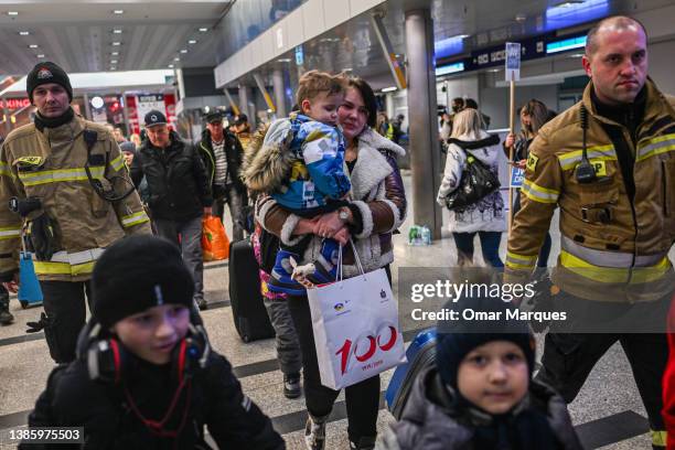 People who fled the war in Ukraine walk towards a humanitarian train which is relocating refugees to Berlin on March 17, 2022 in Krakow, Poland. More...
