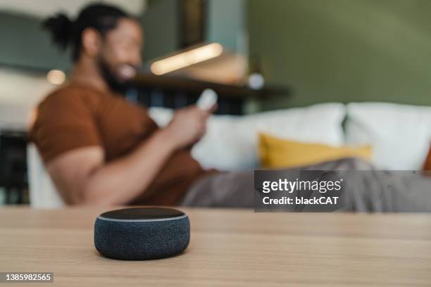 smart speaker on the table in the living room. - speech recognition stock pictures, royalty-free photos & images