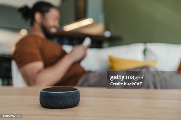 smart speaker on the table in the living room. - virtual assistant stock pictures, royalty-free photos & images