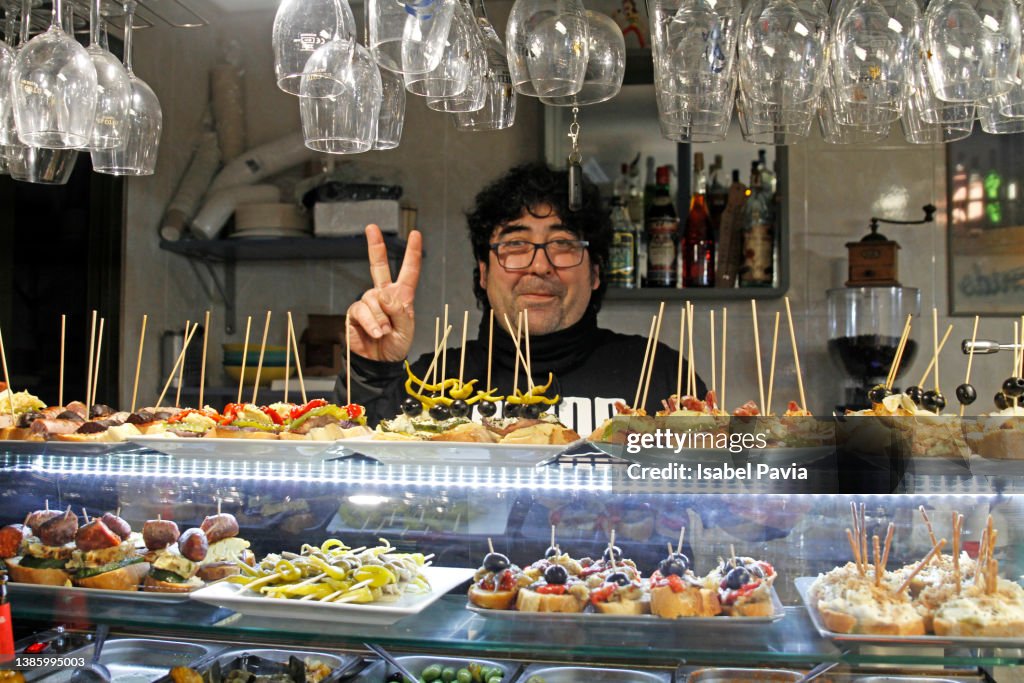 Waiter at restaurant, standing behind the counter