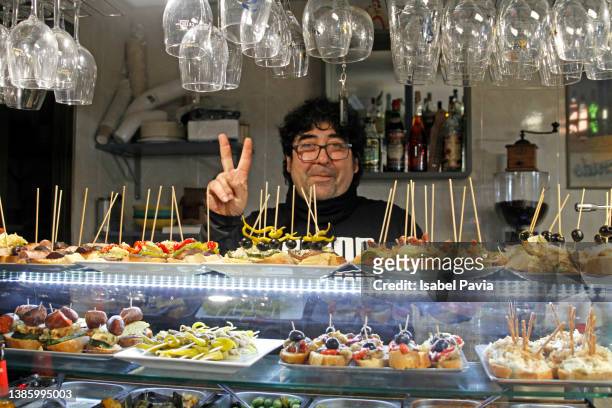 waiter at restaurant, standing behind the counter - tapas stock pictures, royalty-free photos & images