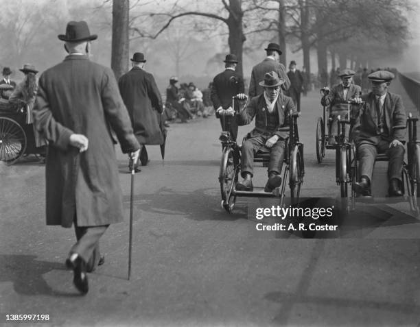 Three disabled veterans of World War I using hand-cranked wheelchairs on Rotten Row in Hyde Park, London, 1st March 1920.