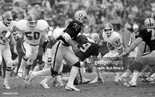Raiders running back Marcus Allen eludes defenders before scoring a touchdown during game action of Los Angeles Raiders vs Denver Broncos, November...