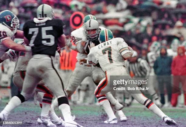 Broncos quarterback John Elway during game action of Los Angeles Raiders vs Denver Broncos, November 24, 1985 in Los Angeles, California.