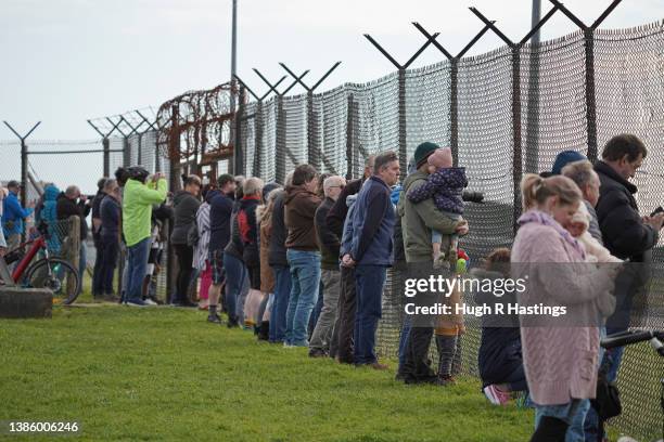 Spectators watch from the perimeter at Culdrose air base on March 17, 2022 in Helston, England. Royal Navy Hawk jets from 736 Naval Air Squadron took...
