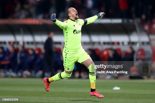 Milan Borjan of Crvena Zvezda celebrates their sides first goal scored by Mirko Ivanic during the UEFA Europa League Round of 16 Leg Two match...