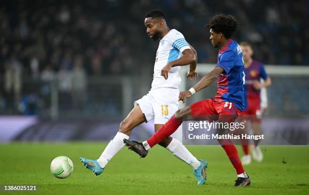 Cedric Bakambu of Marseille is challenged by Andy Pelmard of FC Basel during the UEFA Conference League Round of 16 Leg Two match between FC Basel...