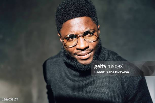 young confident african american man in stylish glasses is looking away, thinking - male model facial expression stock pictures, royalty-free photos & images