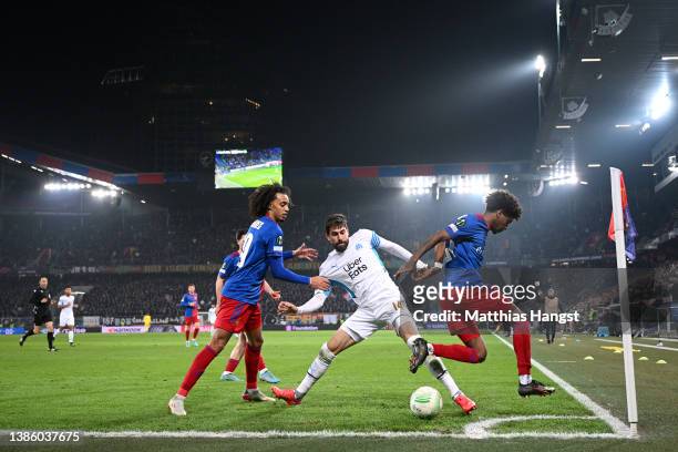 Sebastiano Esposito and Andy Pelmard of FC Basel battle for possession with Luan Peres of Marseille during the UEFA Conference League Round of 16 Leg...