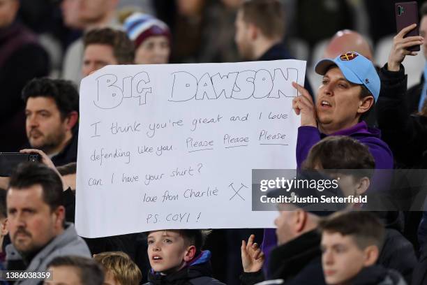 West Ham United fan holds a sign asking for the shirt of Craig Dawson of West Ham United prior to the UEFA Europa League Round of 16 Leg Two match...