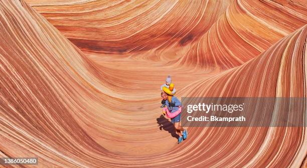 father and toddler daughter exploring the famous wave of coyote buttes north in the paria canyon-vermilion cliffs wilderness of the colorado plateau in southern utah and northern arizona usa - the wave utah stock pictures, royalty-free photos & images