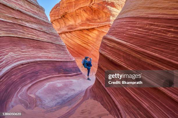 mother and daughter exploring the famous wave of coyote buttes north in the paria canyon-vermilion cliffs wilderness of the colorado plateau in southern utah and northern arizona usa - the wave coyote buttes stock pictures, royalty-free photos & images