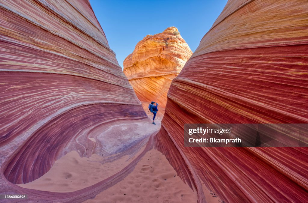 Mother and Daughter Exploring the Famous Wave of Coyote Buttes North in the Paria Canyon-Vermilion Cliffs Wilderness of the Colorado Plateau in Southern Utah and Northern Arizona USA