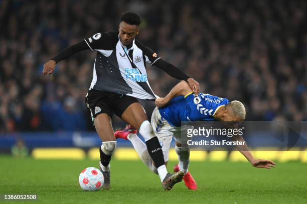 Joe Willock of Newcastle United is challenged by Richarlison of Everton during the Premier League match between Everton and Newcastle United at...