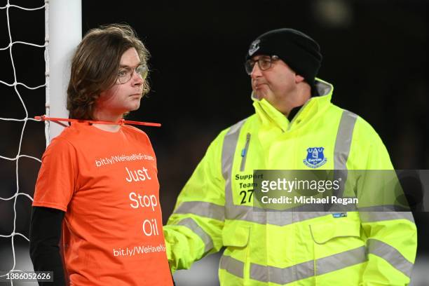 Fan ties himself to the net in protest during the Premier League match between Everton and Newcastle United at Goodison Park on March 17, 2022 in...