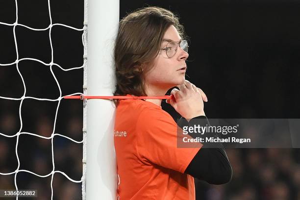 Fan ties himself to the net in protest during the Premier League match between Everton and Newcastle United at Goodison Park on March 17, 2022 in...