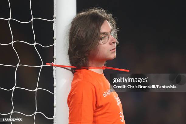 Protestor ties himself to the goalpost during the Premier League match between Everton and Newcastle United at Goodison Park on March 17, 2022 in...