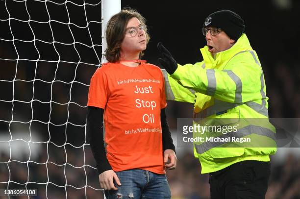 Steward reacts after a protester ties himself to the net during the Premier League match between Everton and Newcastle United at Goodison Park on...