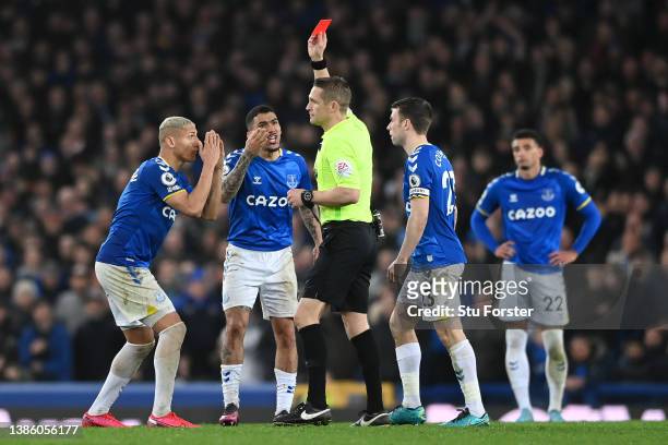 Richarlison of Everton reacts as Allan of Everton is shown a red card from referee Craig Pawson during the Premier League match between Everton and...