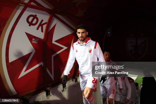 Cristiano Piccini of Crvena Zvezda makes his way out onto the pitch the UEFA Europa League Round of 16 Leg Two match between Crvena Zvezda and...