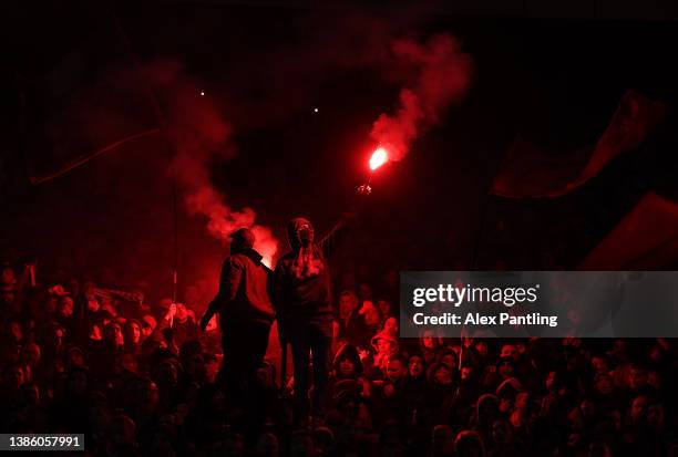 Fans light flares during the UEFA Europa League Round of 16 Leg Two match between Crvena Zvezda and Rangers FC at Rajko Mitic Stadium on March 17,...