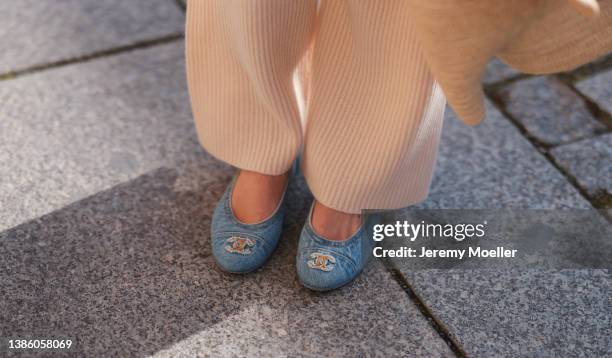 Leo Eberlin seen wearing beige cozy wool knit pants from Allude and denim ballerinas from Chanel during Berlin Fashion Week on March 16, 2022 in...