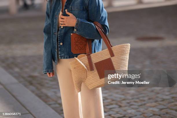 Leo Eberlin seen wearing a beige cozy wool knit pants from Allude, Leo Mathild diamond rings, a blue denim jeans Loewe jacket with leather Loewe...