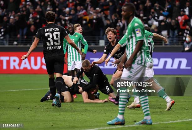 Goncalo Paciencia, Kristijan Jakic and Sam Lammers of Eintracht Frankfurt celebrate after Guido Rodriguez of Real Betis scores Eintracht Frankfurt's...