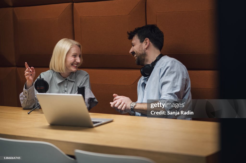 Two young hosts recording a podcast