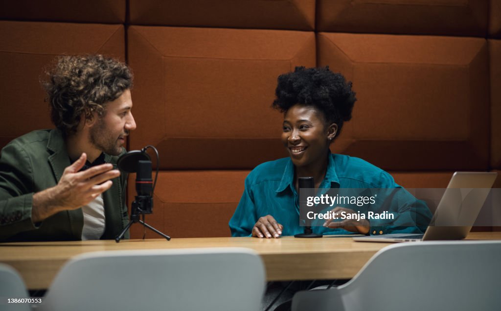 Two young hosts commenting on newest business news
