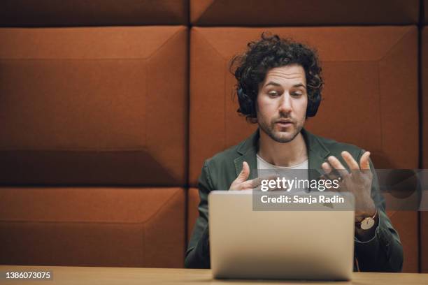 young attractive man explaining new business strategy on a video call meeting - media interview stock pictures, royalty-free photos & images