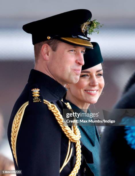 Prince William, Duke of Cambridge and Catherine, Duchess of Cambridge stand on a dais to take the salute as they attend the annual St. Patrick's Day...