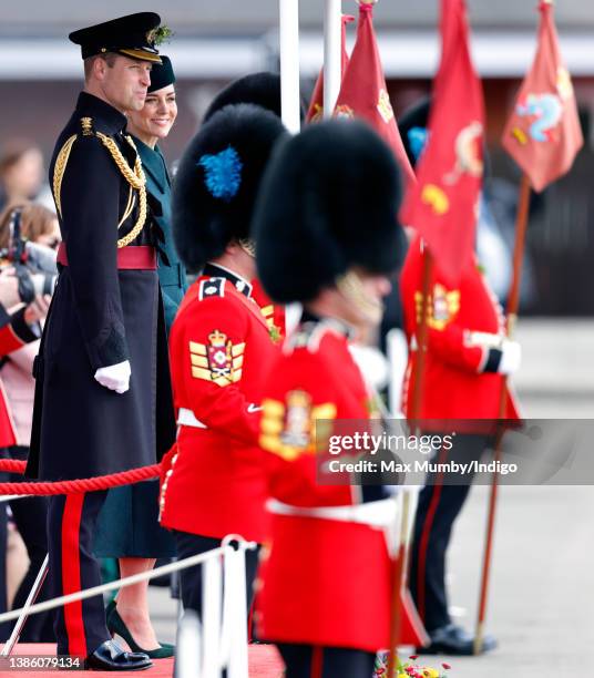 Prince William, Duke of Cambridge and Catherine, Duchess of Cambridge stand on a dais to take the salute as they attend the annual St. Patrick's Day...