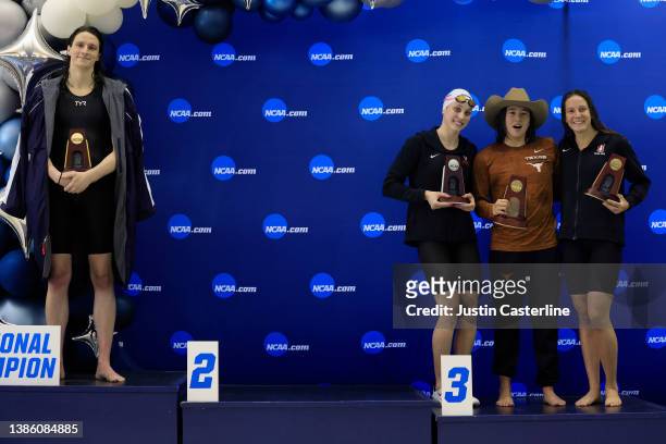Transgender woman Lia Thomas of the University of Pennsylvania stands on the podium after winning the 500-yard freestyle as other medalists Emma...