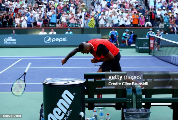 Nick Kyrgios of Australia smashes his racket after his three set defeat against Rafael Nadal of Spain in their quarterfinal match on Day 11 of the...