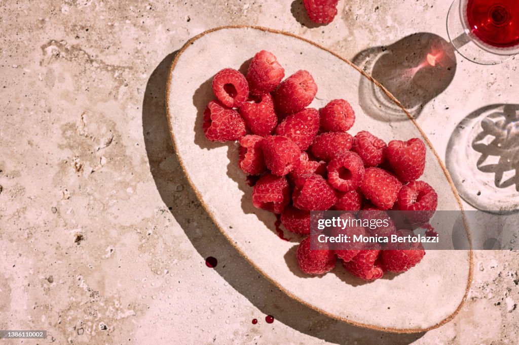Raspberries in oval plate hard light summer vibes